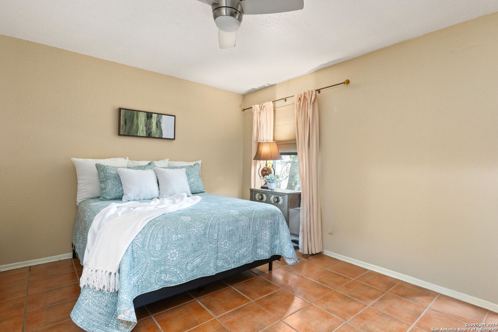 11520 Huebner Road, Unit 102 San Antonio, TX 78230 - Photo 9 of 15 a bedroom with a bed and a night stand