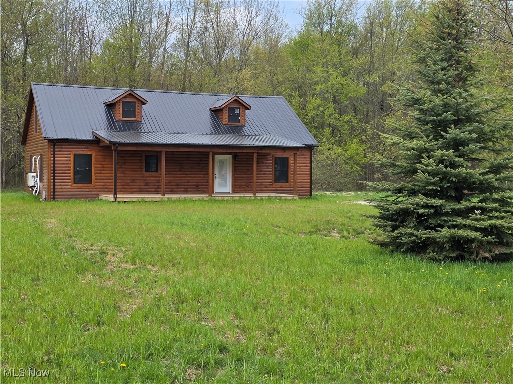2239 Eureka Road Ashtabula, OH 44004 - Photo 1 of 22 Log cabin featuring a porch and metal roof