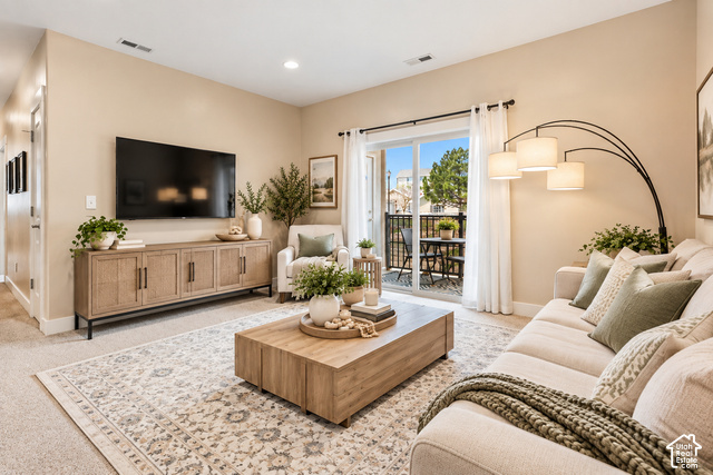 2156 Springtime Drive Saratoga Springs, UT 84045 - Photo 2 of 16 Sliding glass door leading to a private outdoor balcony, recessed ceiling lighting, wall-mounted television, and a wood-finish media console