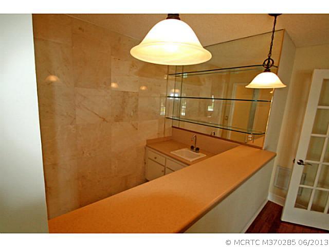 1144 Northwest Spruce Ridge Drive Stuart, FL 34994 - Photo 14 of 25 Exterior Front. Wet bar with mirrored wall and sink