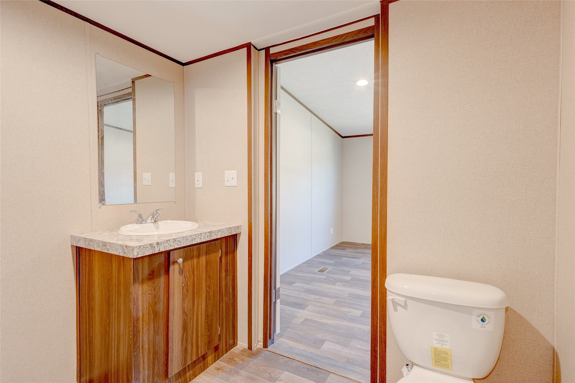 107 Los Cueva Road Elgin, TX 78621 - Photo 24 of 31 Half bathroom with light wood-type flooring, vanity, ornamental molding, and recessed lighting