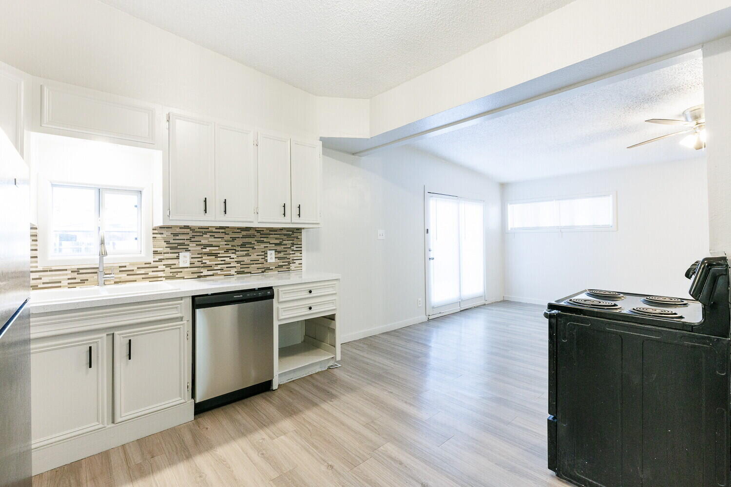 4402 44th Street Lubbock, TX 79414 - Photo 12 of 34 a kitchen with granite countertop a sink cabinets and wooden floor
