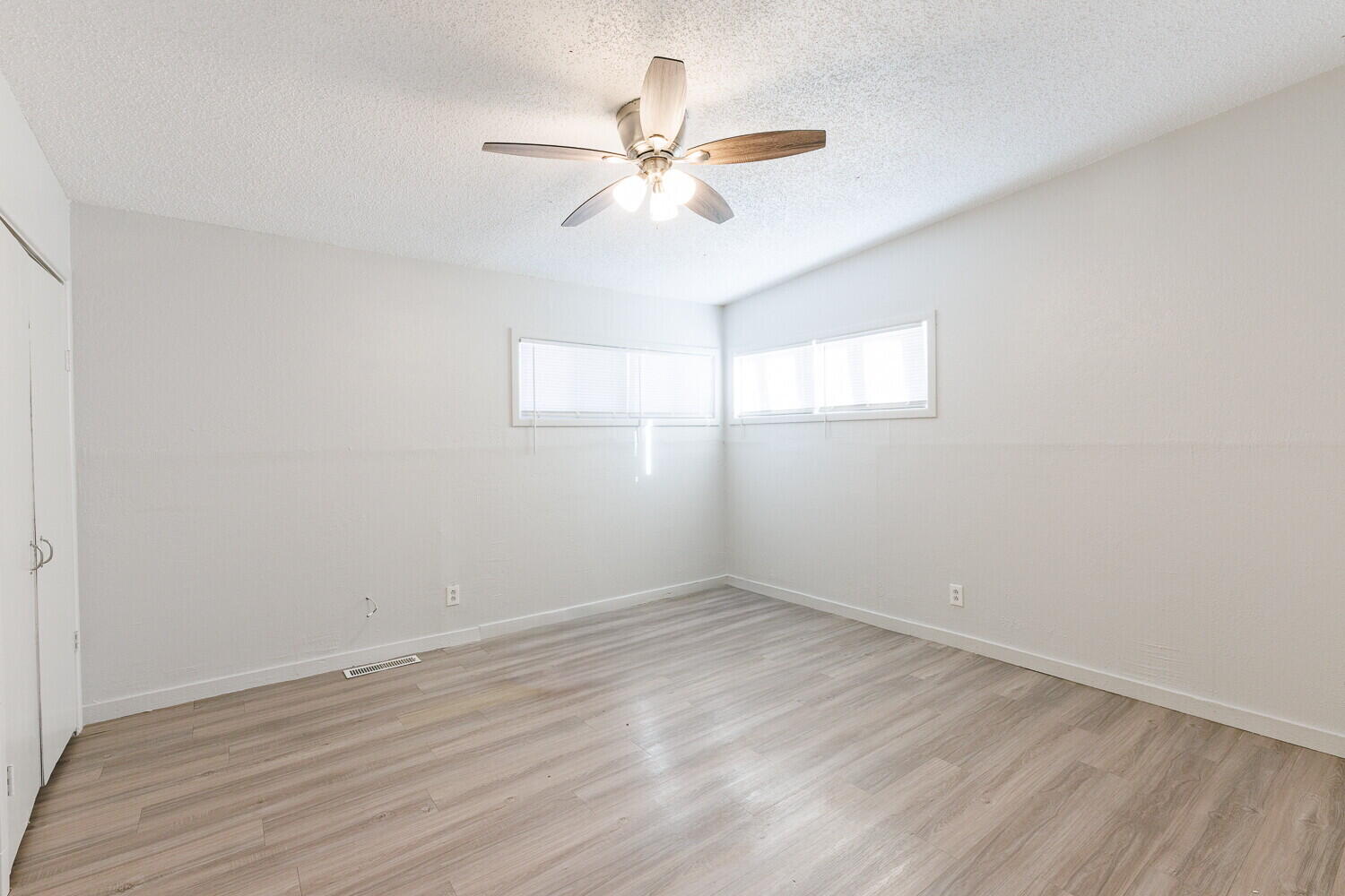 4402 44th Street Lubbock, TX 79414 - Photo 22 of 34 a view of a room with wooden floor and a ceiling fan