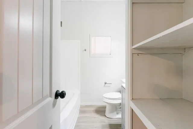 a bathroom with a sink a toilet and mirror