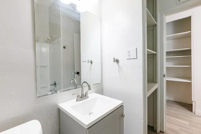 a view of a hallway with wooden floor and closet