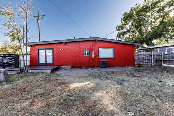 a view of a small barn with wooden fence