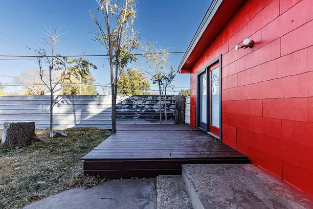 a view of a house with a wooden deck