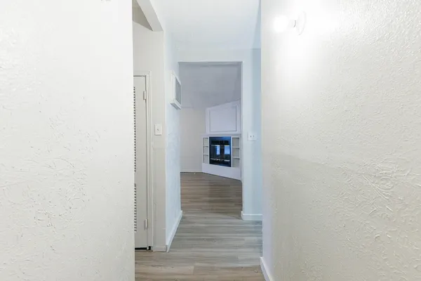 a view of a hallway with wooden floor