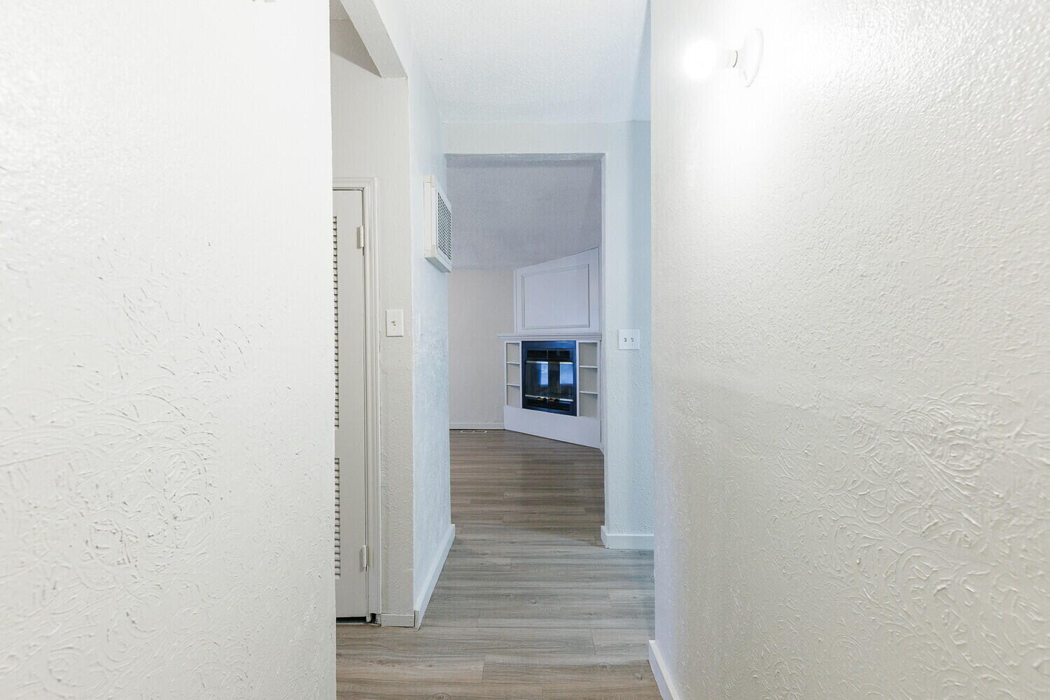 4402 44th Street Lubbock, TX 79414 - Photo 4 of 34 a view of a hallway with wooden floor and a bathroom