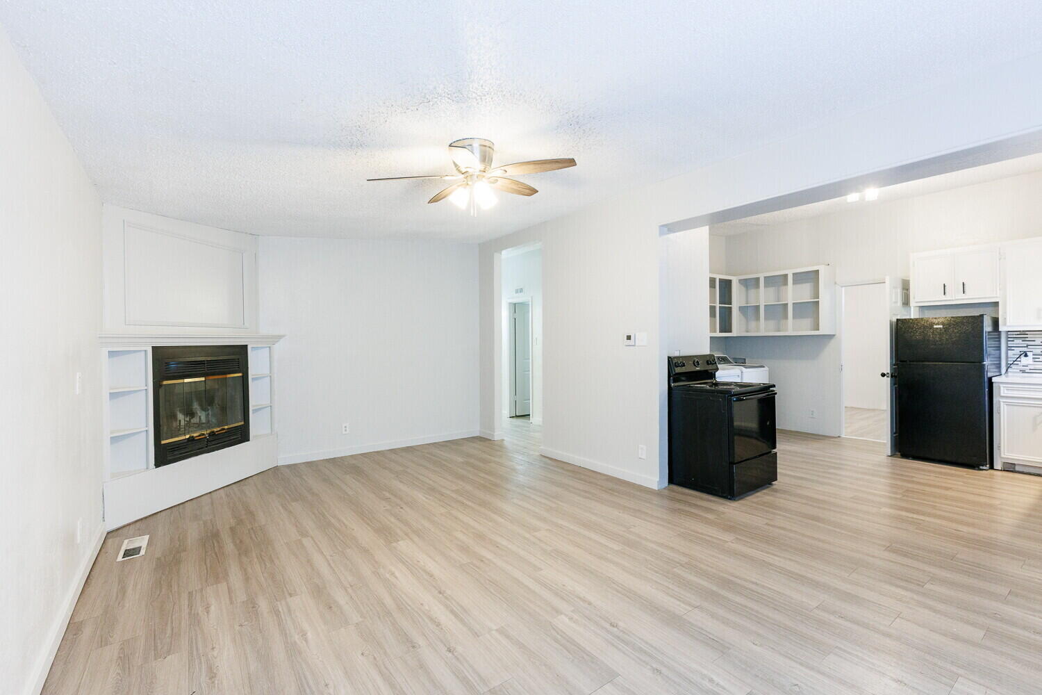 4402 44th Street Lubbock, TX 79414 - Photo 6 of 34 a view of a kitchen with wooden floor and a ceiling fan