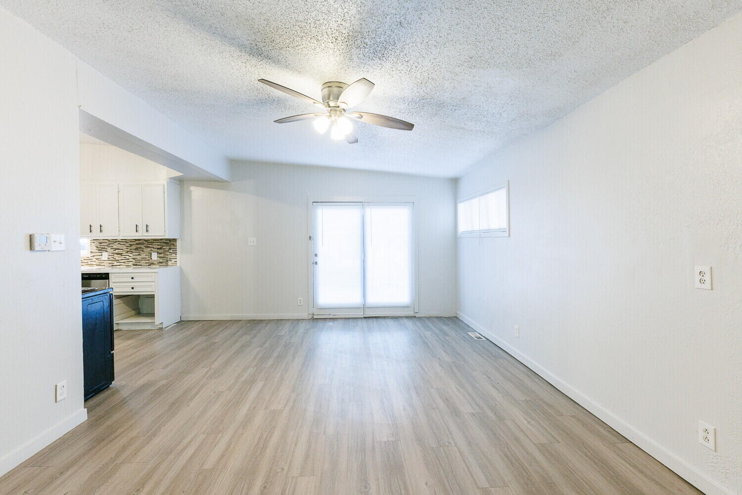 4402 44th Street Lubbock, TX 79414 - Photo 8 of 34 a view of a kitchen with a dishwasher a kitchen island hardwood floor and a window