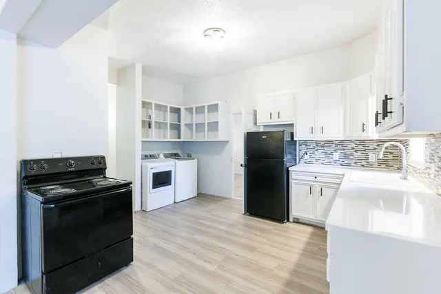 a kitchen with a refrigerator and a sink