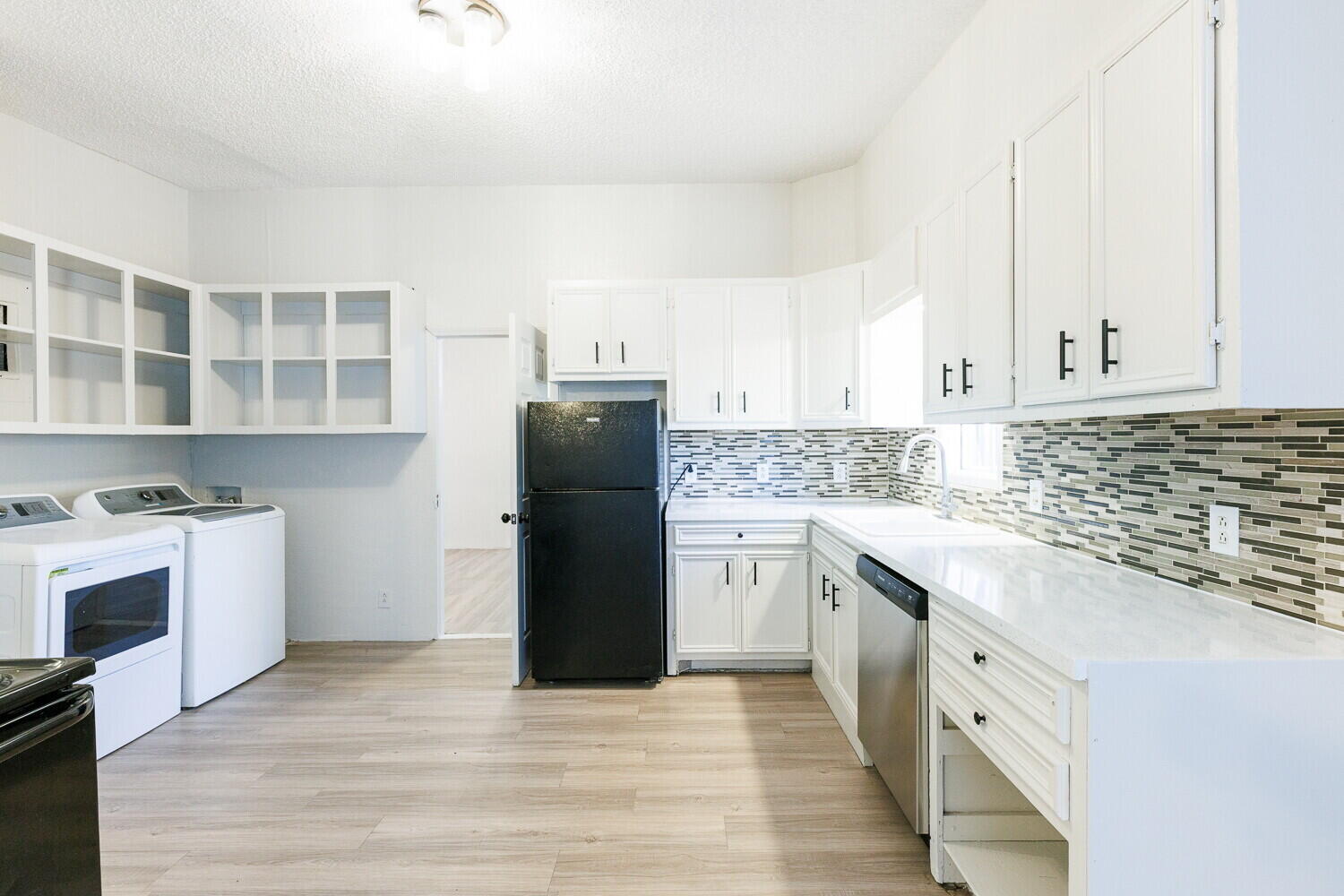 4402 44th Street Lubbock, TX 79414 - Photo 10 of 34 a kitchen with a refrigerator and a sink