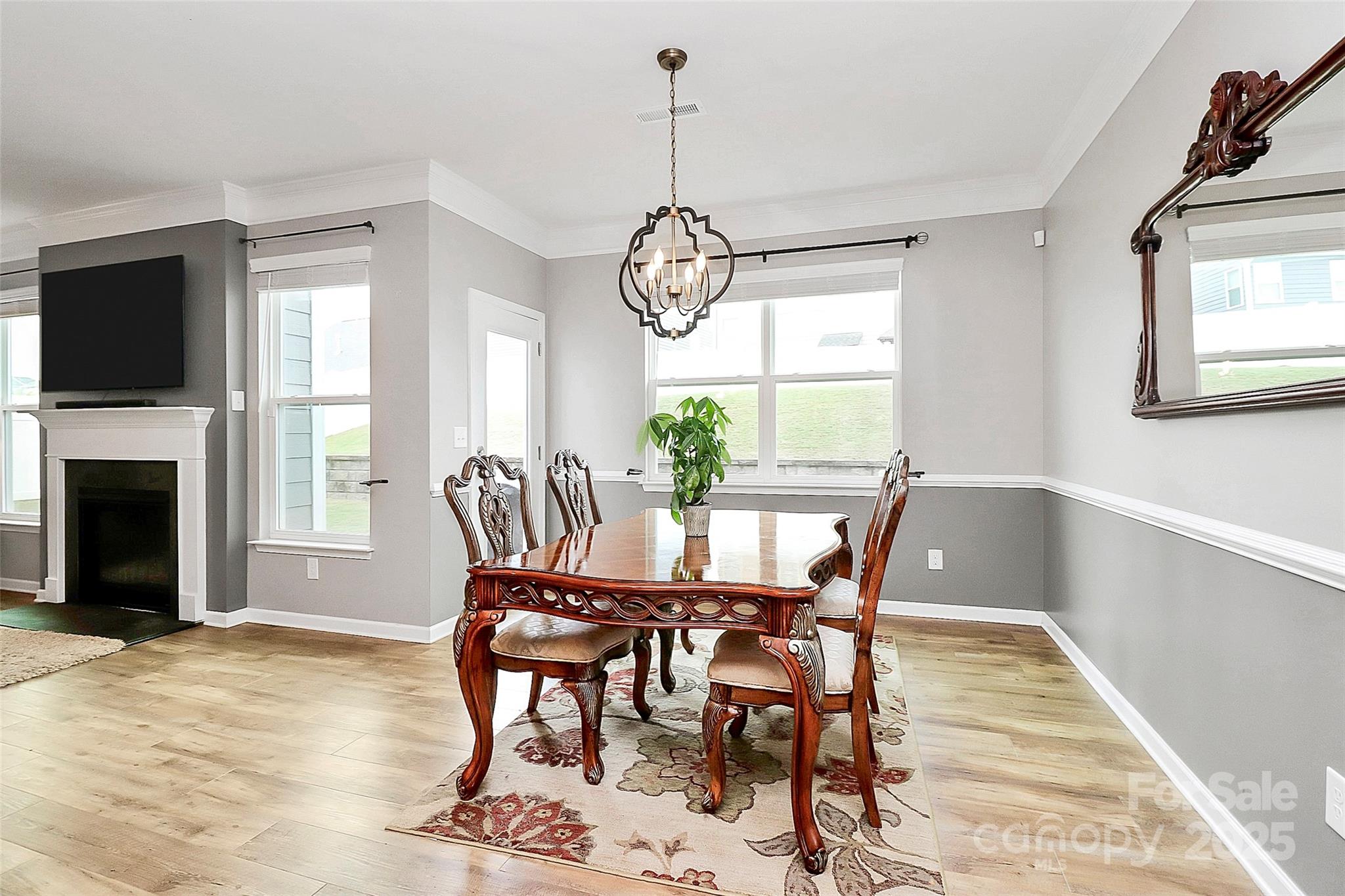 1093 Baldwin Drive Lancaster, SC 29720 - Photo 12 of 42 a dining room with furniture a chandelier and wooden floor