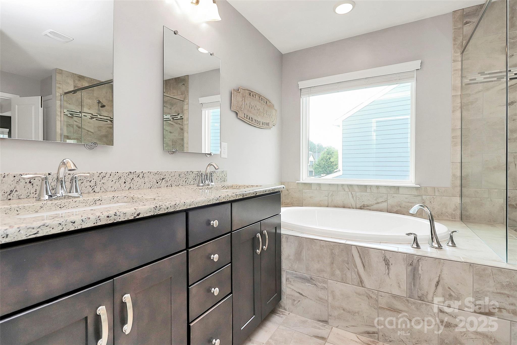 1093 Baldwin Drive Lancaster, SC 29720 - Photo 35 of 42 a bathroom with a granite countertop bathtub sink double vanity and mirror