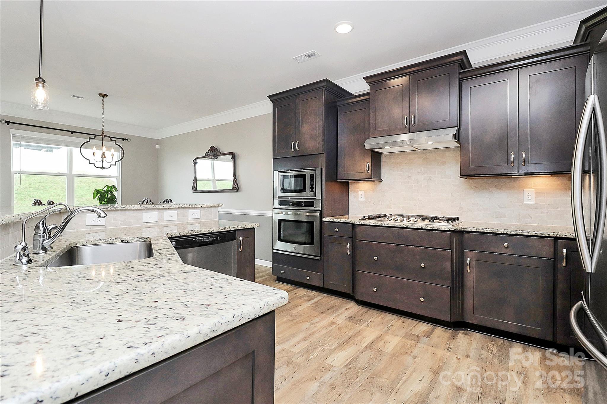 1093 Baldwin Drive Lancaster, SC 29720 - Photo 7 of 42 a kitchen with stainless steel appliances kitchen island granite countertop a sink a stove and a refrigerator