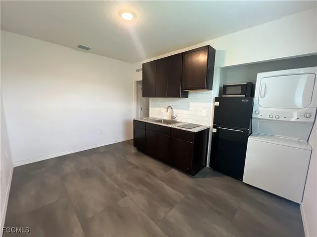 a room with a flat screen tv and washer