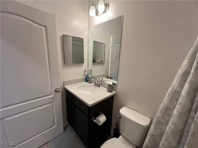a bathroom with a sink toilet and mirror