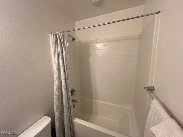 a bathroom with a shower and a toilet