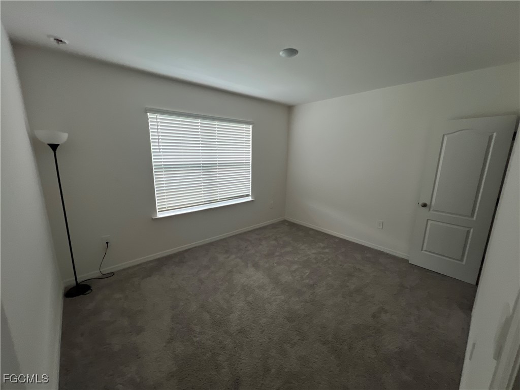 4301 17th Street Southwest Lehigh Acres, FL 33976 - Photo 6 of 7 an empty room with windows