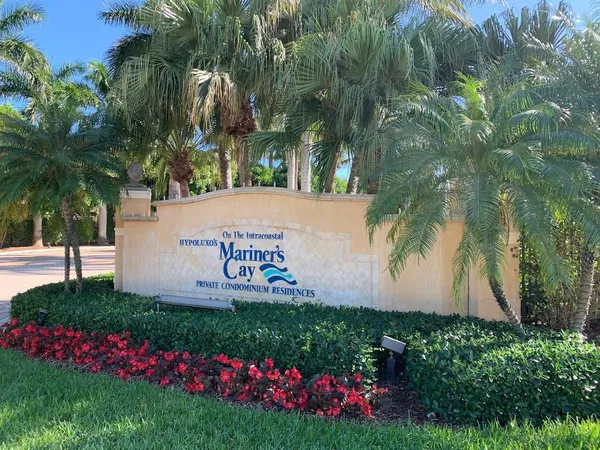 a sign that is sitting in front of flowers