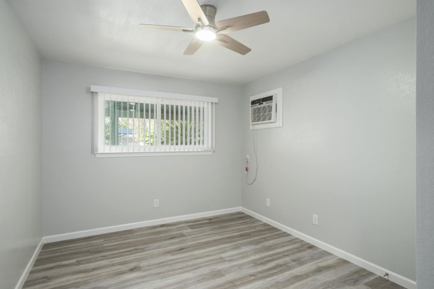 3062 Jasper Street Selma, CA 93662 - Photo 11 of 26 wooden floor in an empty room with a window