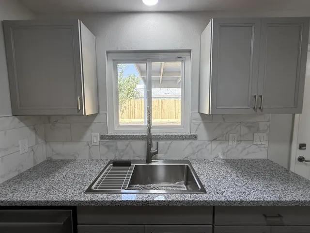 a kitchen with sink and window