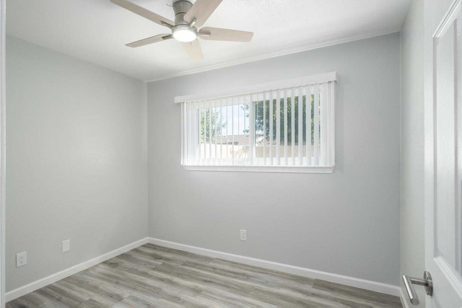 3062 Jasper Street Selma, CA 93662 - Photo 17 of 26 an empty room with a window and ceiling fan