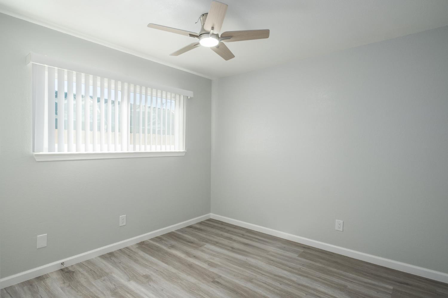 3062 Jasper Street Selma, CA 93662 - Photo 18 of 26 wooden floor in an empty room with a window