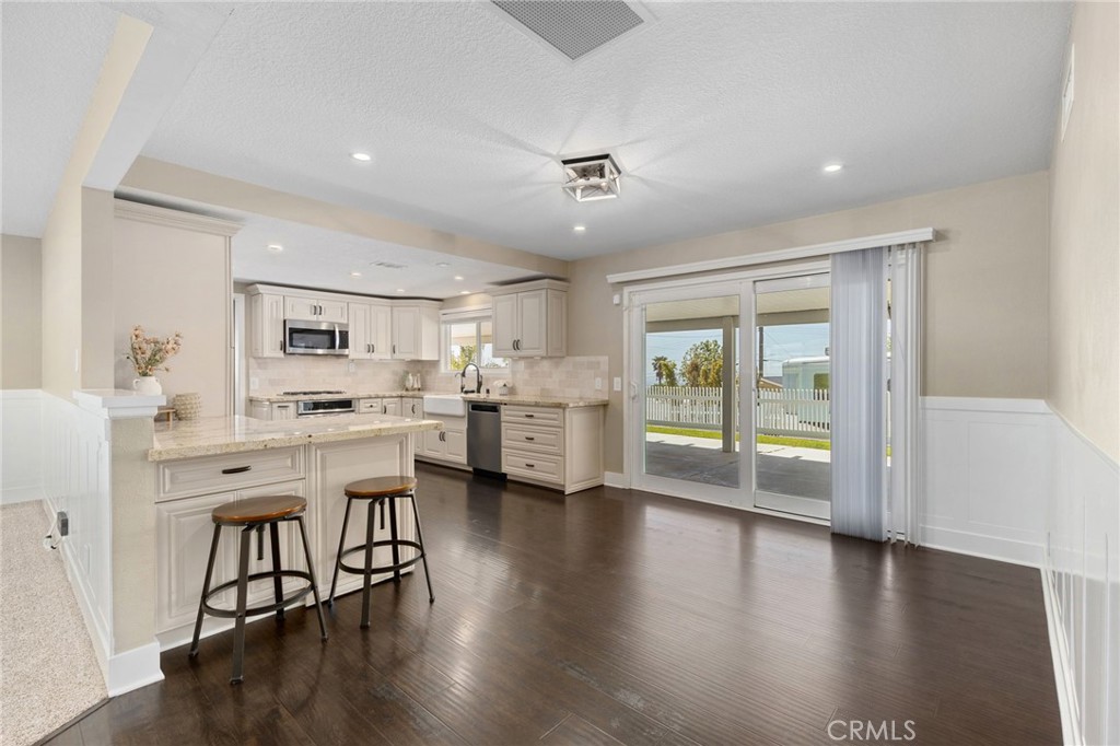 8729 Hillside Road Rancho Cucamonga, CA 91701 - Photo 15 of 66 a open kitchen with white cabinets and stainless steel appliances