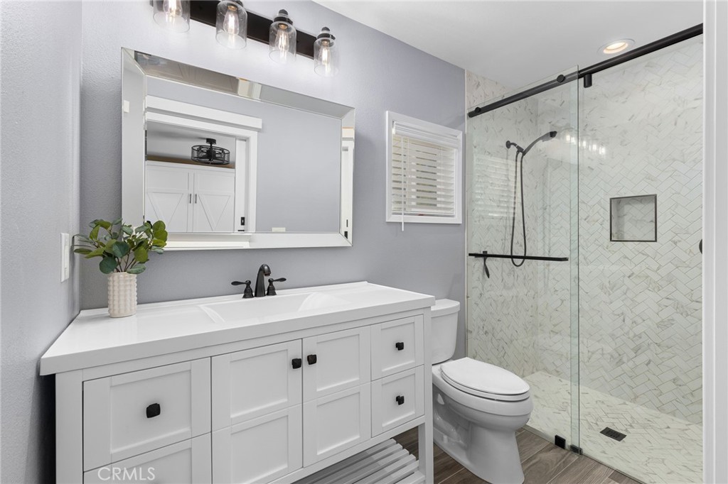 8729 Hillside Road Rancho Cucamonga, CA 91701 - Photo 28 of 66 a bathroom with a sink a toilet and shower