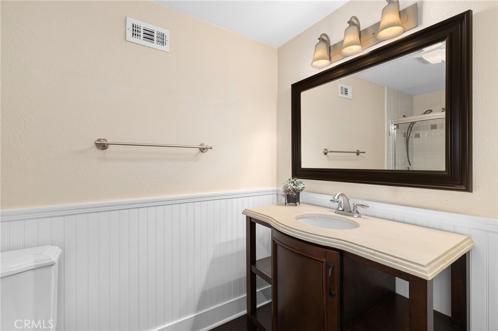8729 Hillside Road Rancho Cucamonga, CA 91701 - Photo 38 of 66 a bathroom with a sink vanity and a mirror