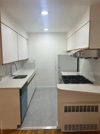 a kitchen that has a sink and a stove