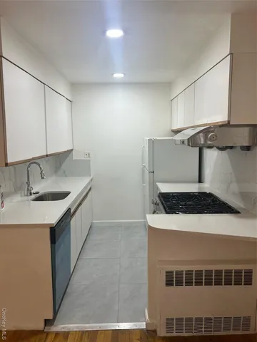 a kitchen that has a sink and a stove