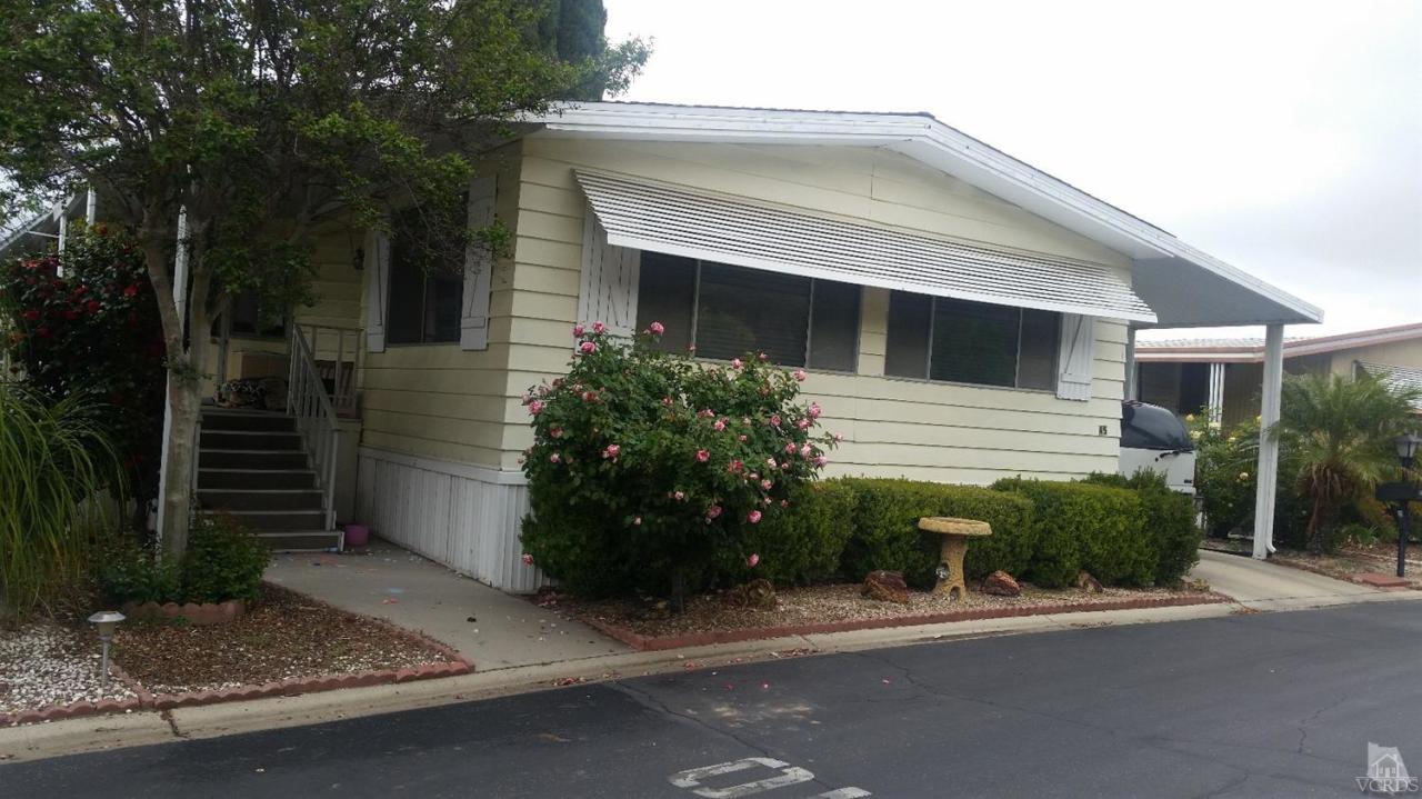 6480 Katherine Road, Unit 45 Simi Valley, CA 93063 - Photo 1 of 3 a front view of a house with a yard