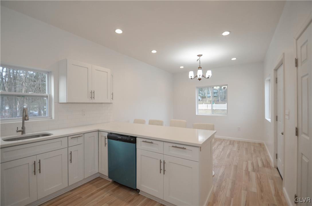 2 Elm Street Mount Pocono, PA 18344 - Photo 11 of 45 a kitchen with white cabinets appliances a sink and a window
