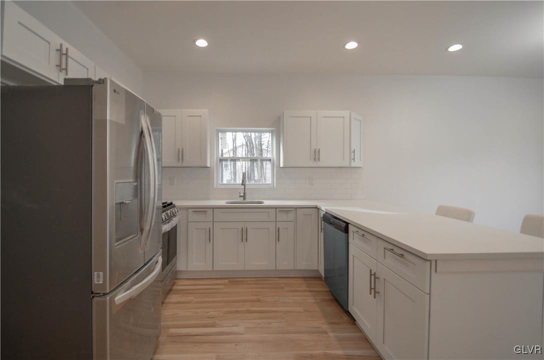 2 Elm Street Mount Pocono, PA 18344 - Photo 9 of 45 a kitchen with white cabinets and refrigerator