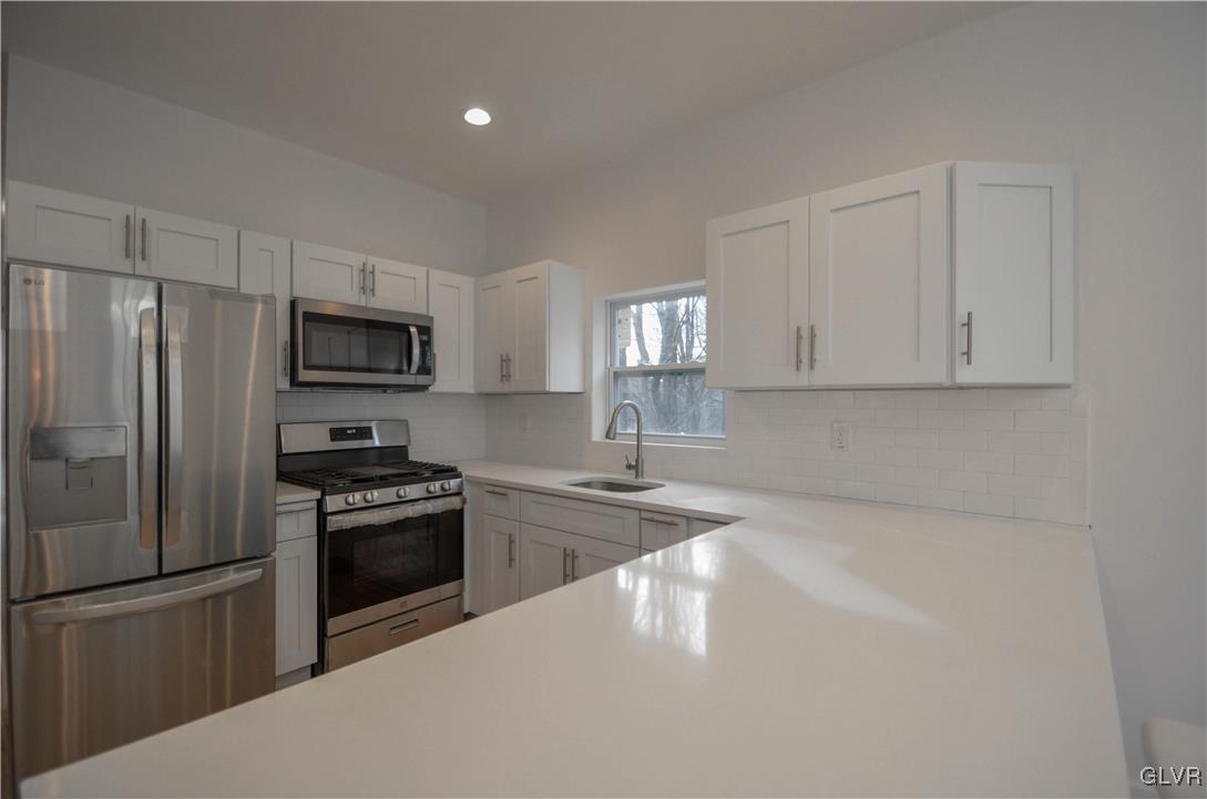 2 Elm Street Mount Pocono, PA 18344 - Photo 10 of 45 a kitchen with granite countertop a refrigerator stove and microwave