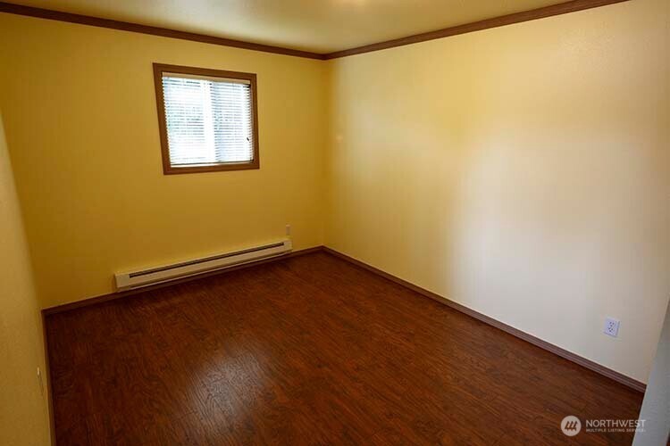 1357 Jacobsen Boulevard Bremerton, WA 98310 - Photo 4 of 7 an empty room with a window and wooden floor