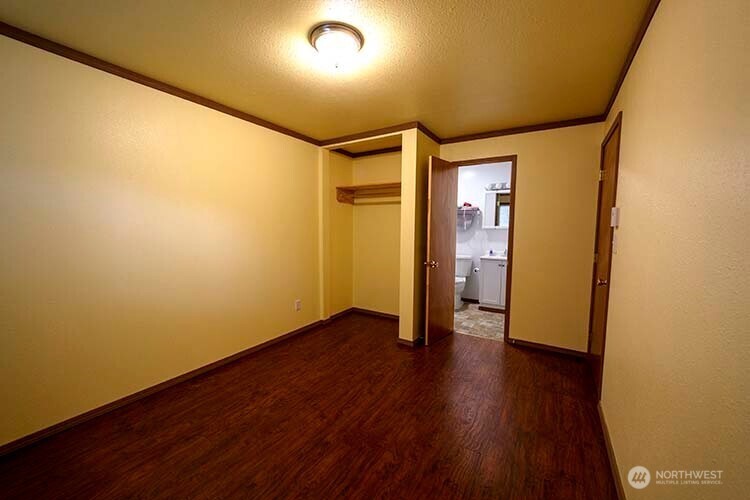 1357 Jacobsen Boulevard Bremerton, WA 98310 - Photo 5 of 7 a view of an empty room with wooden floor and a window