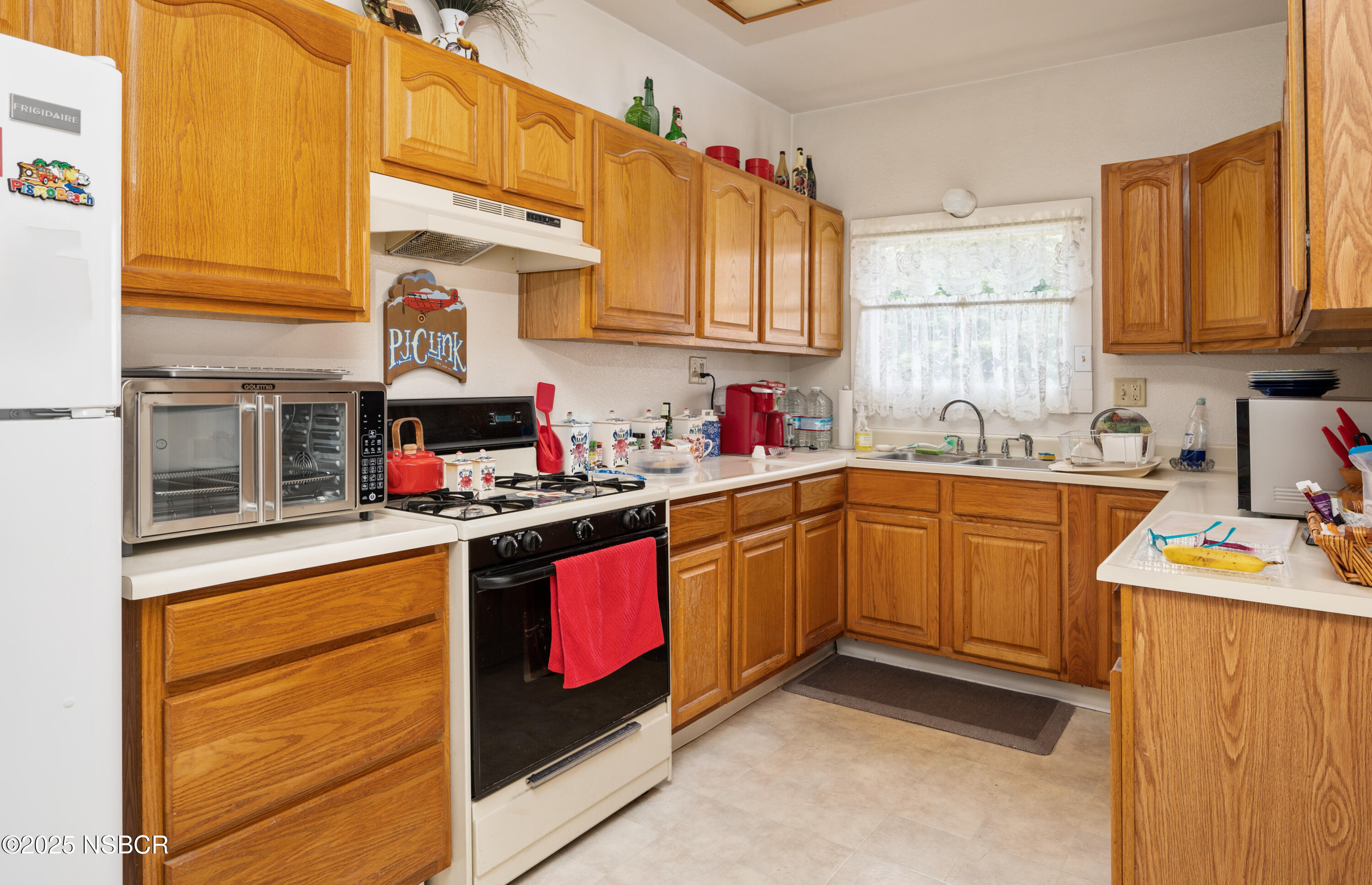 414 West Walnut Avenue Lompoc, CA 93436 - Photo 7 of 17 a kitchen with stainless steel appliances granite countertop a sink stove and cabinets