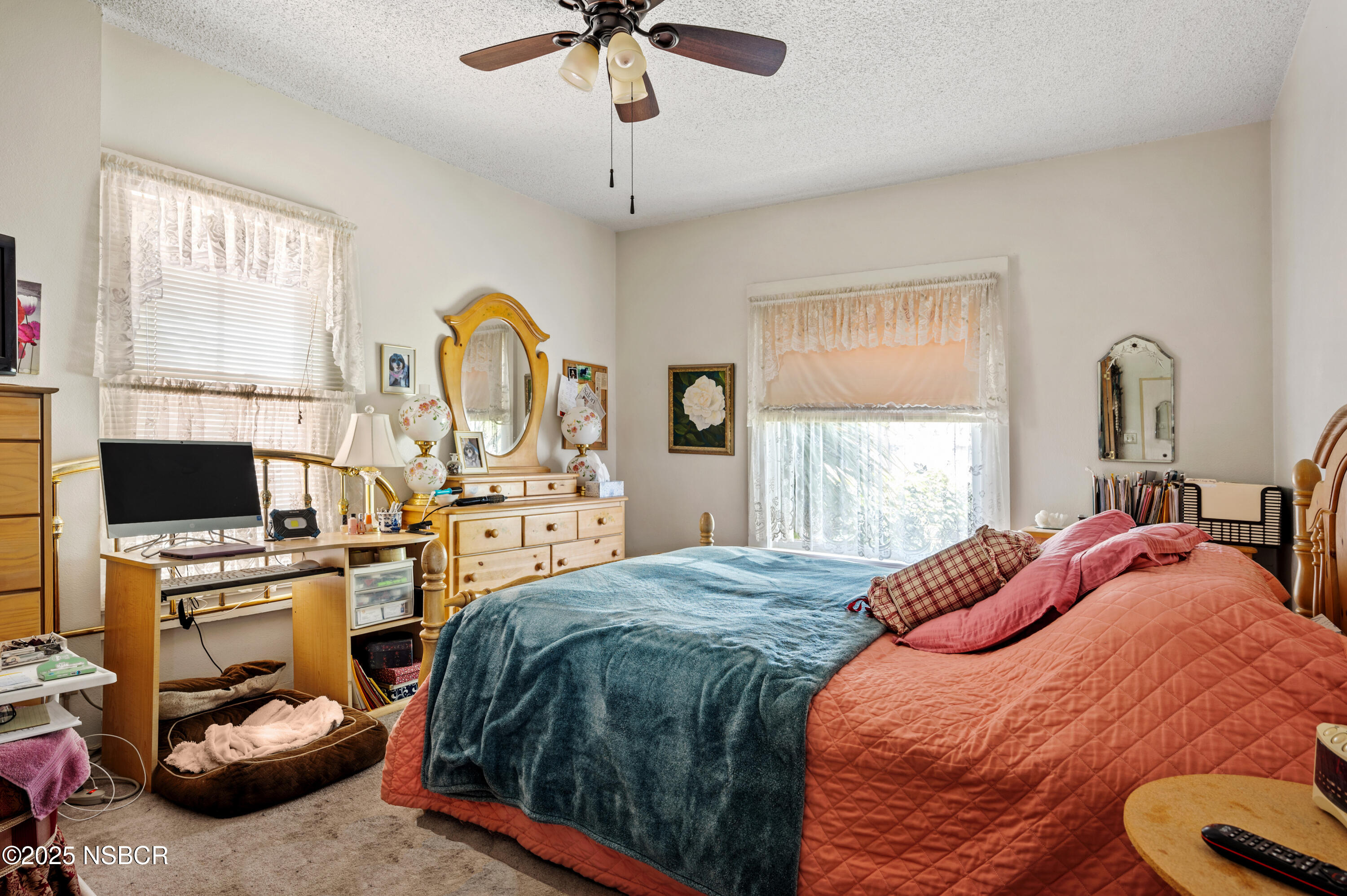 414 West Walnut Avenue Lompoc, CA 93436 - Photo 8 of 17 a bedroom with a bed and a flat screen tv