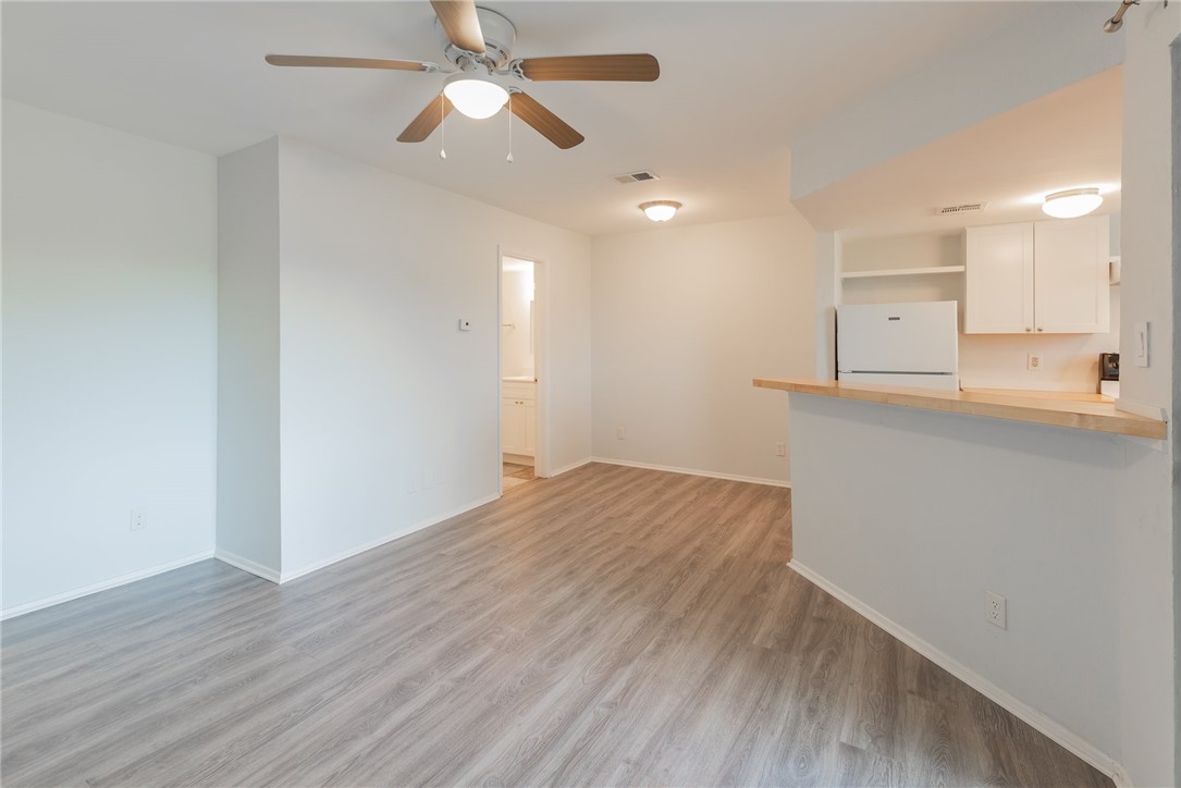 2500 Burleson Road, Unit 614 Austin, TX 78741 - Photo 2 of 20 a view of empty room with wooden floor and fan