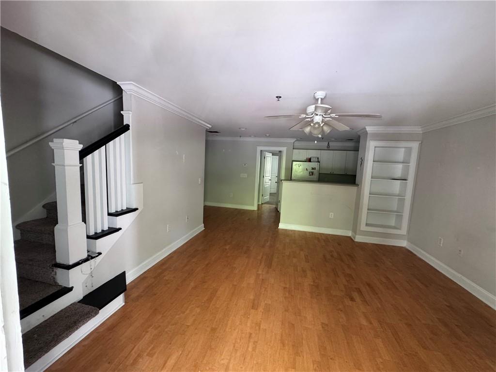 490 South Barnett Shoals Road, Unit 920 Athens, GA 30605 - Photo 2 of 19 a view of a kitchen and an empty room with wooden floor
