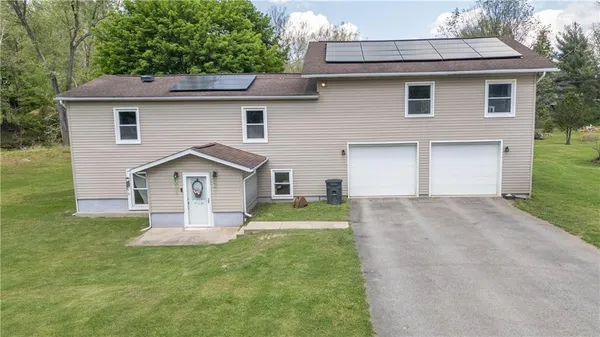 a front view of a house with a yard and garage