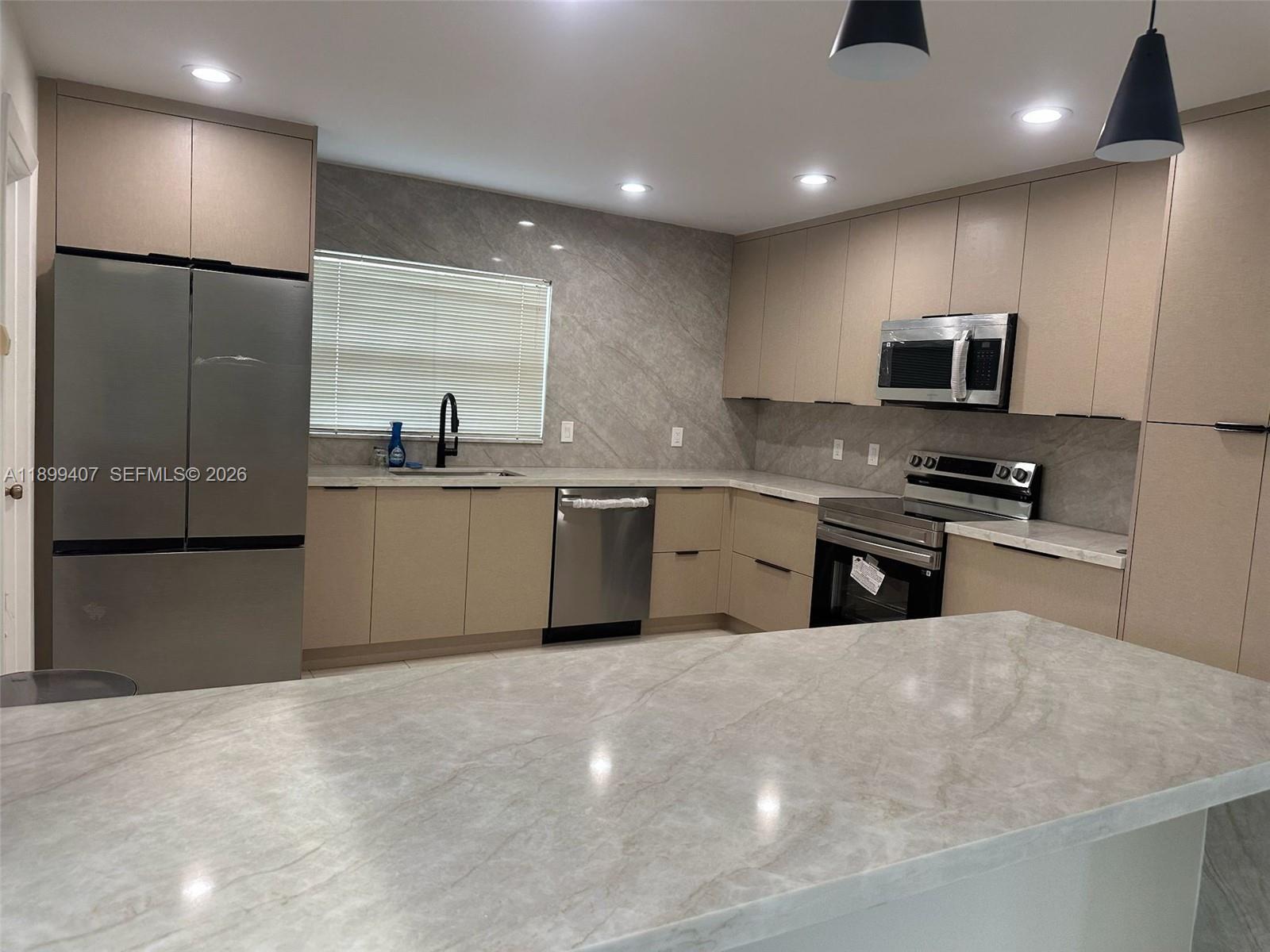 21686 Arriba Real, Unit 40A Boca Raton, FL 33433 - Photo 14 of 53 a kitchen with stainless steel appliances granite countertop a sink a stove a refrigerator and a microwave