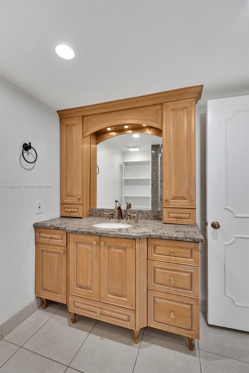 21686 Arriba Real, Unit 40A Boca Raton, FL 33433 - Photo 27 of 53 a bathroom with a granite countertop sink and a mirror