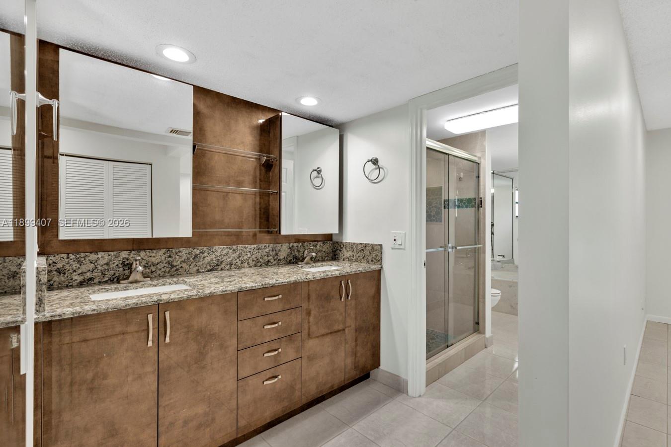 21686 Arriba Real, Unit 40A Boca Raton, FL 33433 - Photo 33 of 53 a bathroom with a granite countertop sink and a mirror