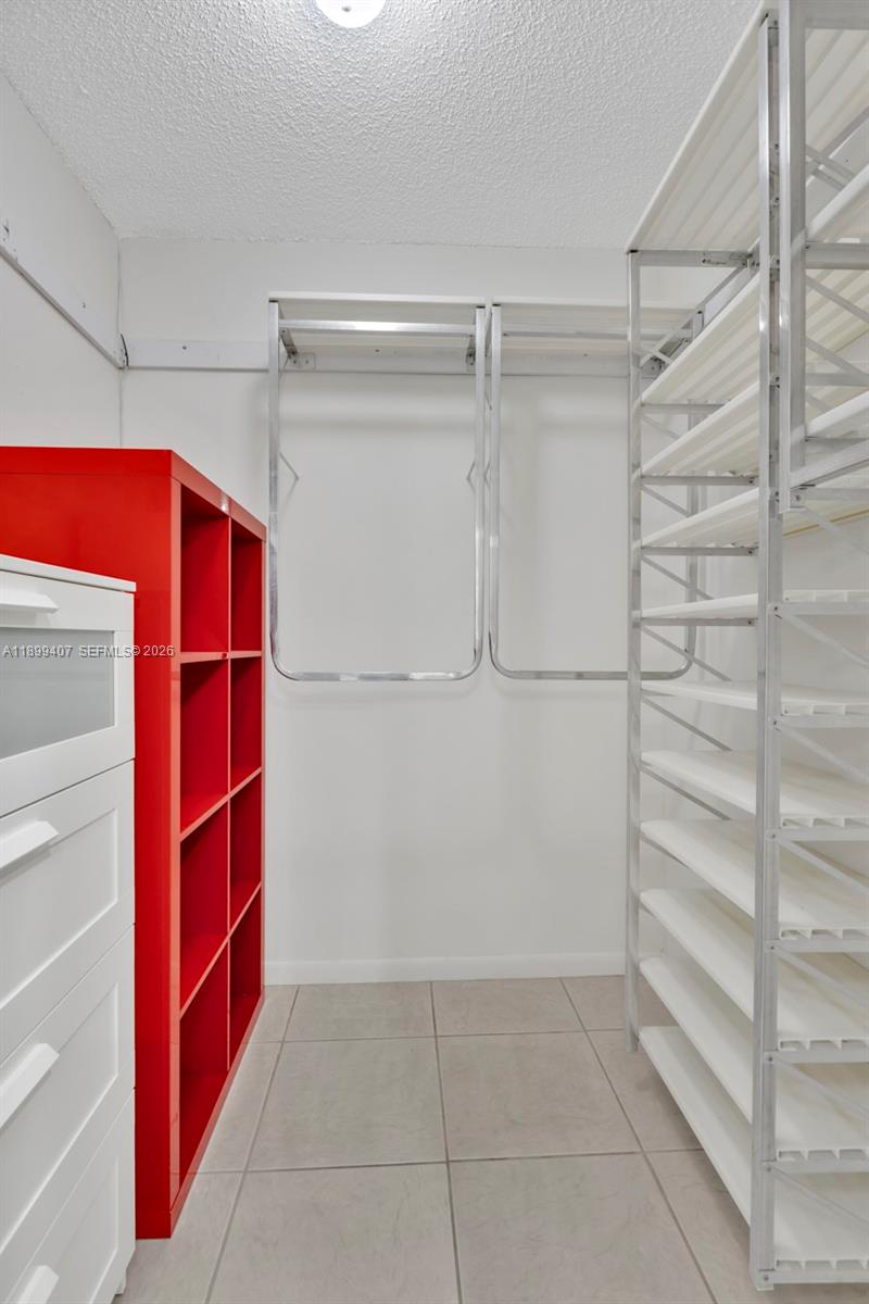 21686 Arriba Real, Unit 40A Boca Raton, FL 33433 - Photo 37 of 53 a view of walk in closet with empty racks