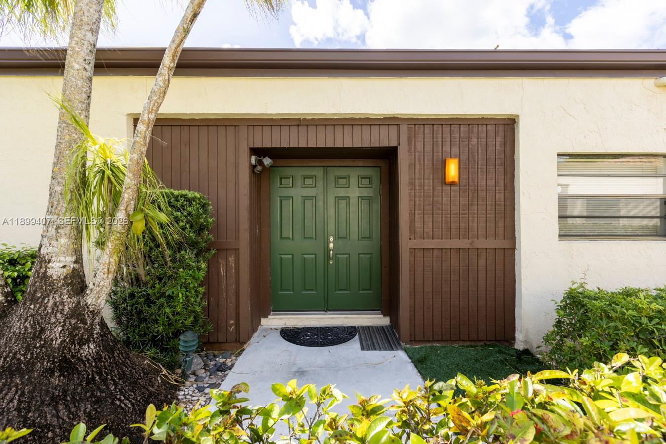 21686 Arriba Real, Unit 40A Boca Raton, FL 33433 - Photo 43 of 53 a front view of a house with a yard